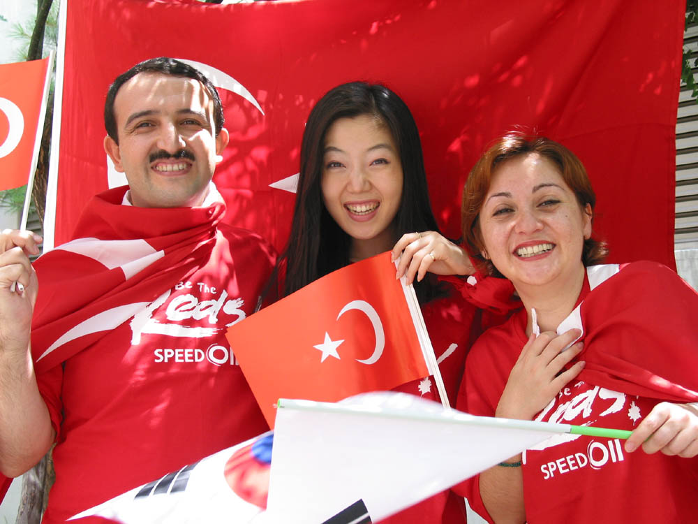 On the 29th of June, 2002, SK Telecom will hold an event to cheer for Korean and Turkish Soccer Teams at the same time in the Seoul City Hall Plaza. The photo shows cheering and swinging of both countries` flags by SK Telecom employees and employees of the Turkish Embassy in Korea.